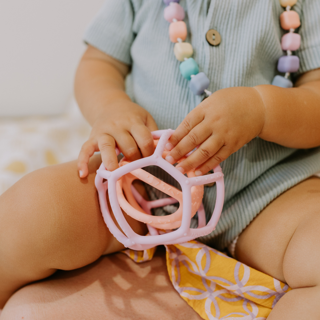 Close up of girls hands playing with sensory ball